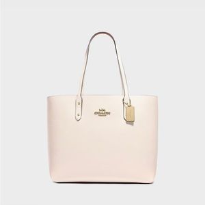 Coach Tote (smaller crossbody purse) Never been used. Off white.